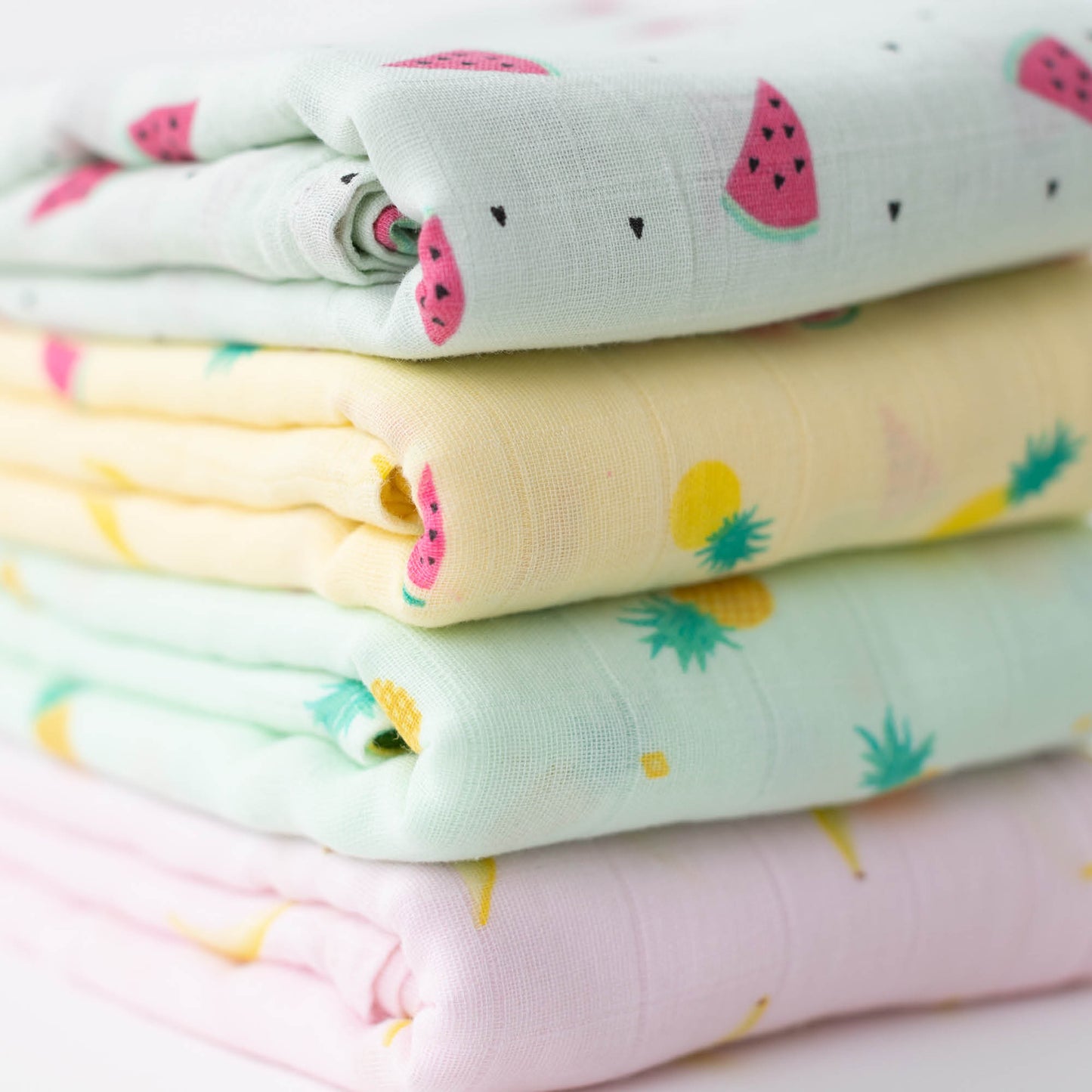 CuddleBug Muslin Cotton Swaddle Blankets (4 Pack) – Tutti Frutti design. Made from 100% premium muslin cotton, these extra-large, breathable 4x4 ft swaddles provide lightweight comfort and cozy security for better sleep.