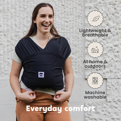 CuddleCarry™ Easy-Wear Baby Wrap Carrier in Black – a lightweight, T-shirt-style baby wrap offering a snug, hands-free fit for newborns to toddlers (8-35 lbs). Ergonomic, adjustable, and designed for all body types (XS-XXL).